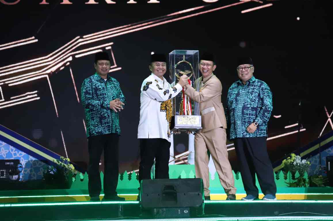 JUARA LAHIR BATIN : Pj Bupati Bekasi Dani Ramdan menerima trophy bergilir Juara Umum MTQ ke-38 tingkat Jawa Barat, dari Sekda Jabar, Herman Suryatman, di Plaza Pemkab Bekasi, pada Sabtu (04/05/2024) malam. FOTO: HUMAS KAB BEKASI.