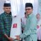 Keterangan foto : Bupati Bandung, Dadang Supriatna, kembali melanjutkan tradisi uniknya membagikan ribuan lembar kain kafan kepada masyarakat pada malam pergantian Tahun Baru Islam 1 Muharam 1448 Hijriah.Acara yang dipusatkan di Dome Balerame Soreang, Jalan Raya Al Fathu, Kabupaten Bandung, pada Senin malam (15/6/2026)