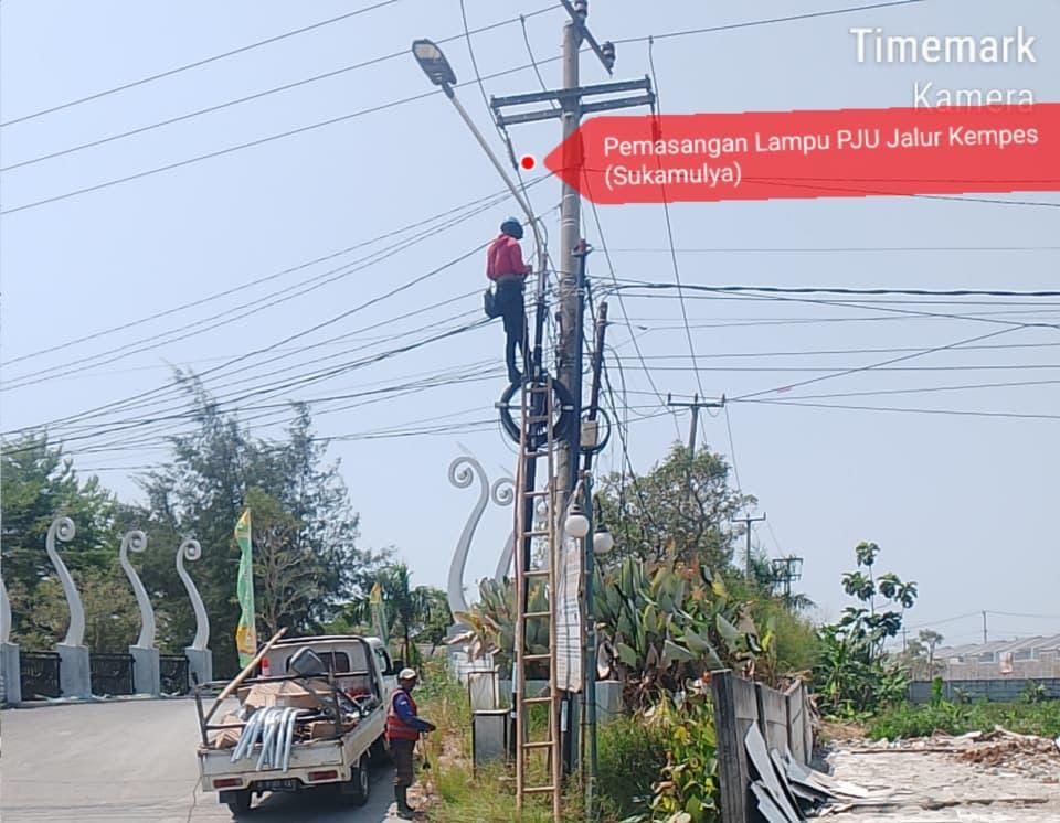 Keterangan foto : Petugas Dishub Kabupaten Bekasi memasang lampu penerangan jalan umum di Sukamulya, Senin 7/9/2026